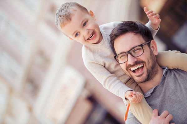 Father with son on his shoulders.